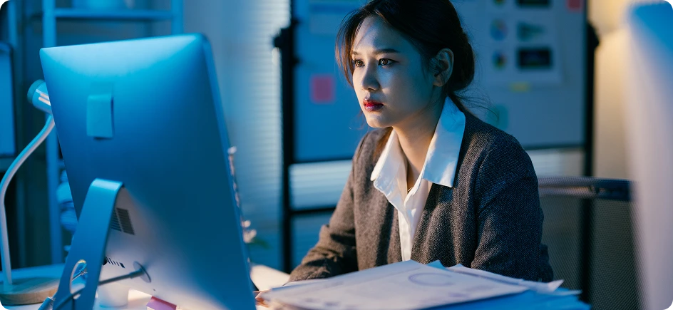The woman works by the computer