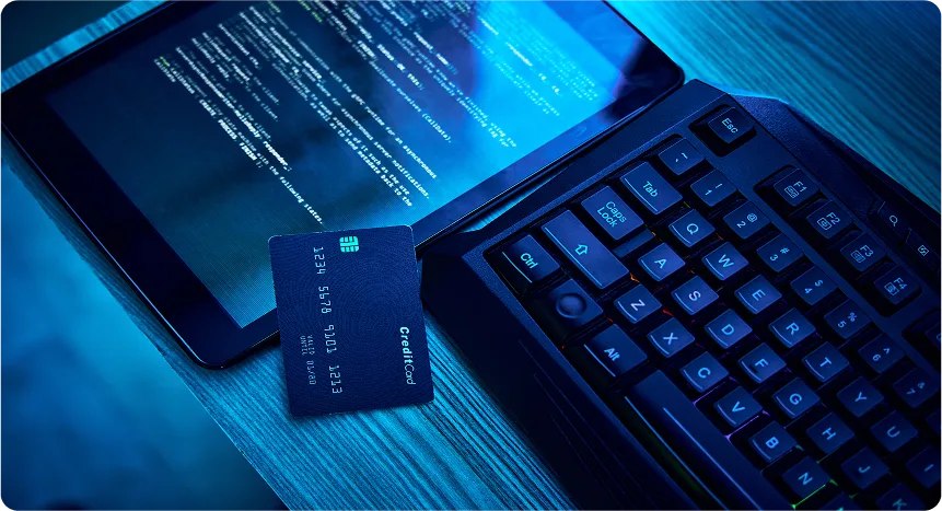 Tablet with code, keyboard, and credit card on desk
