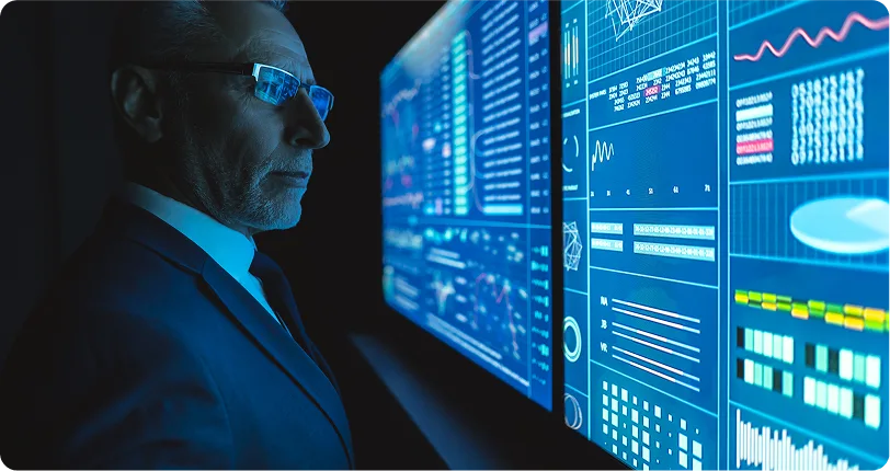 Professional man observing large digital data screens